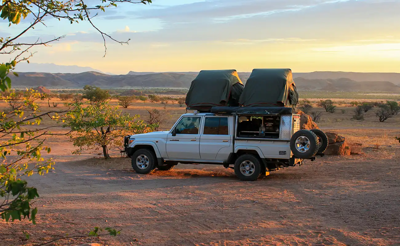 4x4 Rental Car with two Rooftop tents open at sunset in Namibia