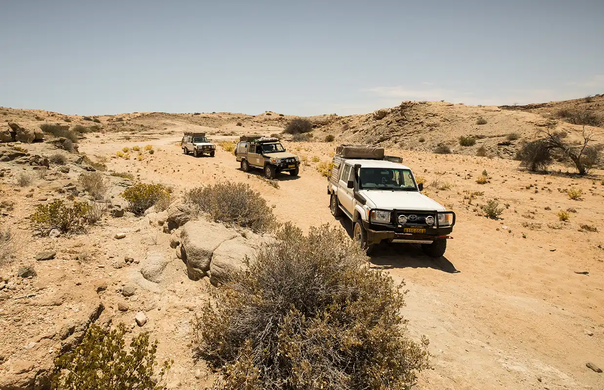 Three 4×4 Rental Cars in Convoy in the dramatic landscape of Namibia Three 4x4 Rental Cars in Convoy in the dramatic landscape of Namibia