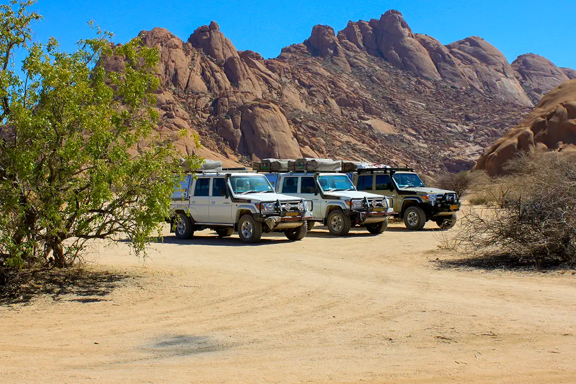 Three Guided 4×4 safari vehicles standing, Namibia Three Guided 4x4 safari vehicles standing, Namibia