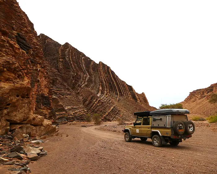 Guided 4×4 safari vehicle on a gravel road in Damaraland, Namibia Guided 4x4 safari vehicle on a gravel road in Damaraland, Namibia