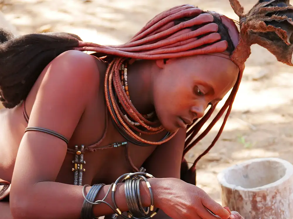 Himba in Namibia preparing food Himba in Namibia preparing food